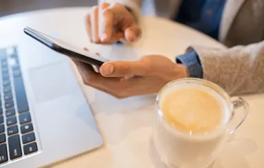 Man with phone and laptop